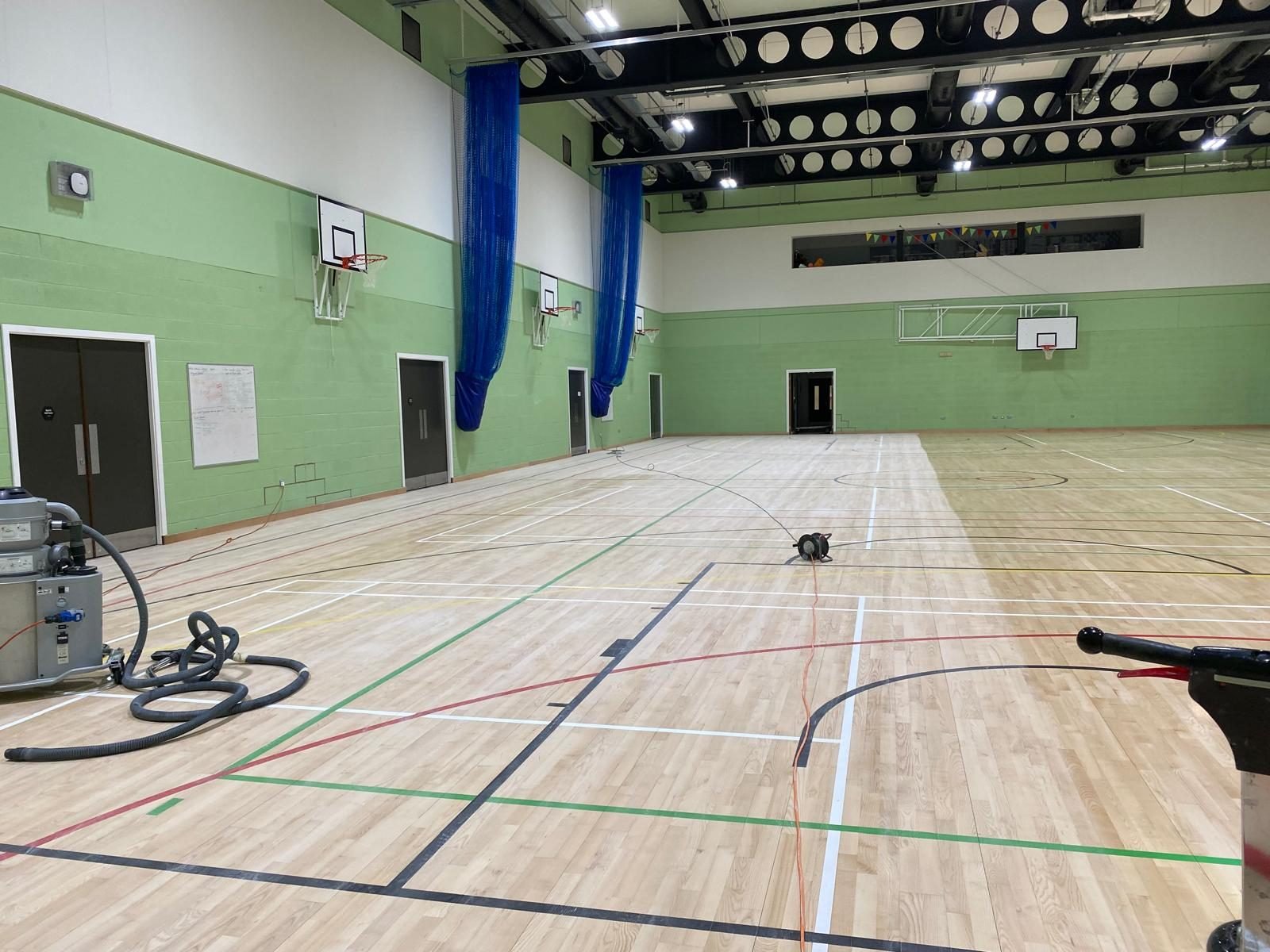 School sports hall floor being sanded